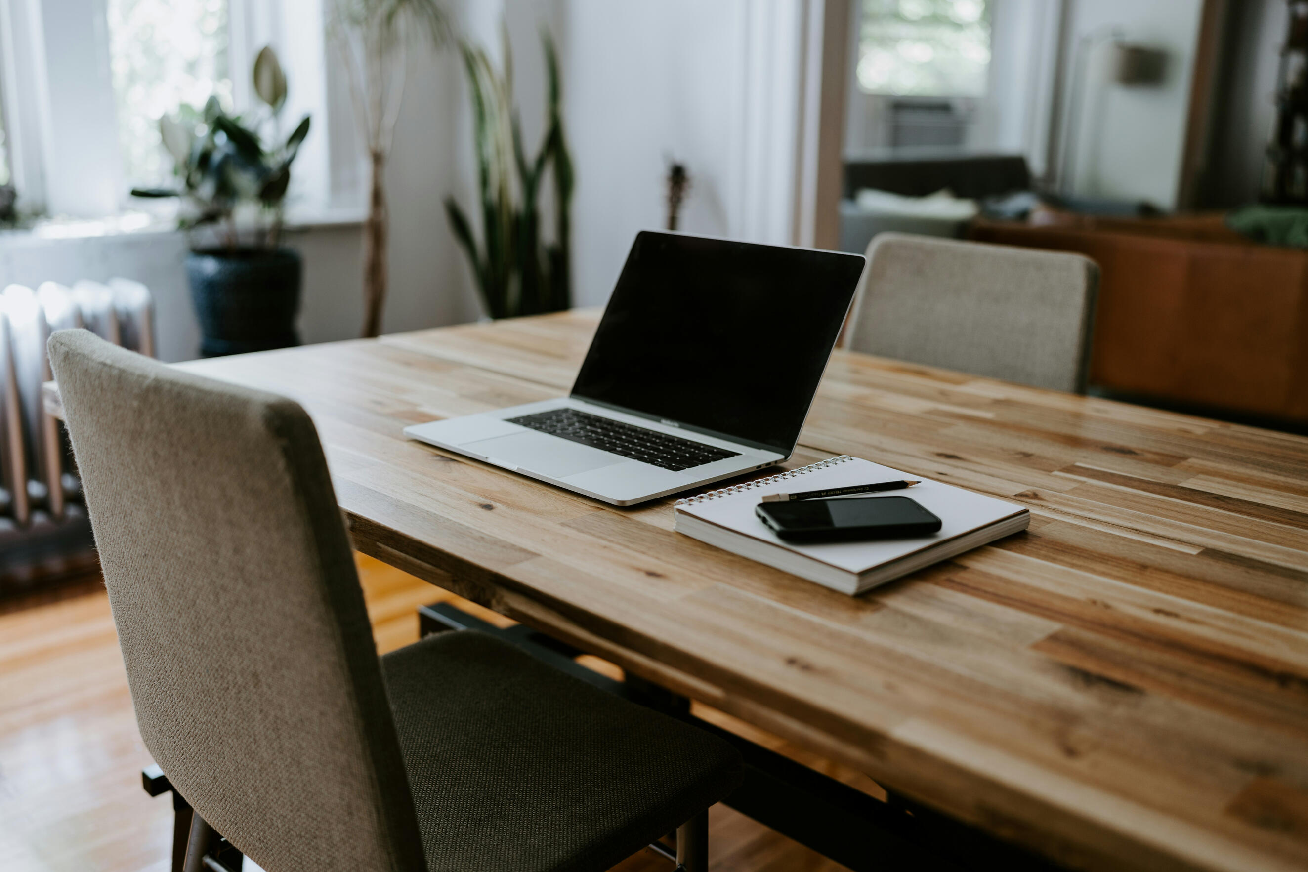 Virtual assistant workspace with laptop and notebook